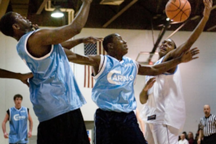 Battling for a rebound are (from left) West's Jason Brogsdale (Collingswood) and Kai Massaquoi (Haddon Heights), and East's Terrance Thorne (Lindenwold). East won the showcase, 112-107.
