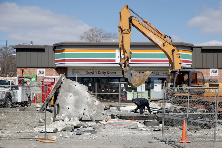 An investigator works at the scene after a gas pump exploded at a 7-Eleven in Philadelphia on March 12, 2019.