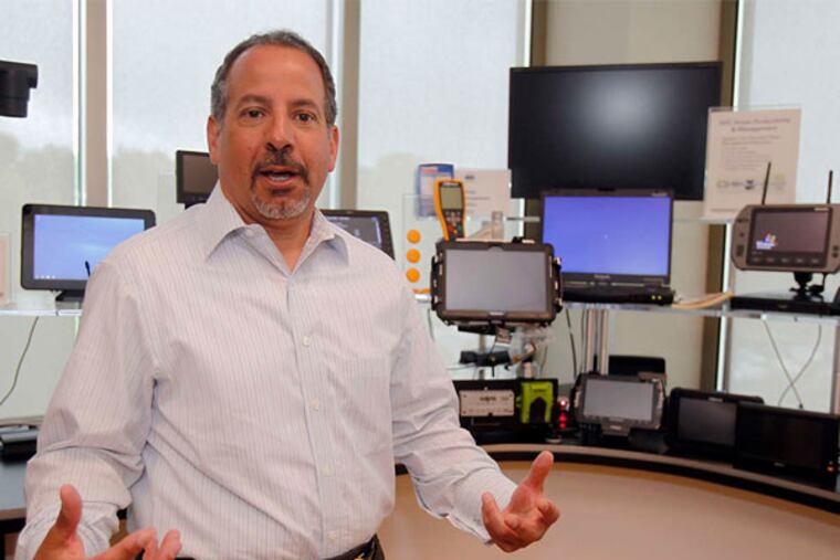 Carl Ortell explains some of ARI's technology at the fleet management company's office in Mount Laurel. ARI, which employs 2,800, was ranked 27th among Fortune's Top 100 Places to Work in 2014. (Akira Suwa / Staff Photographer)