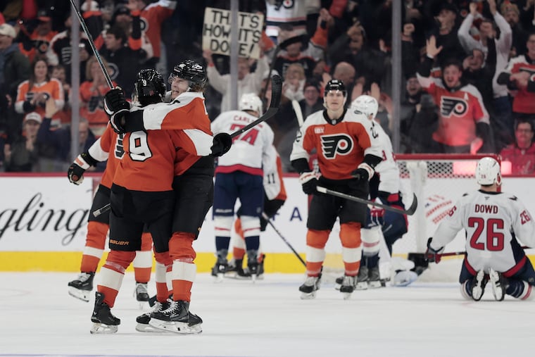 Flyers' Trevor Zegras hugs Jamie Drysdale (left) after Drysdale gave the Flyers a 3-2 lead in the third period against the Washington Capitals.