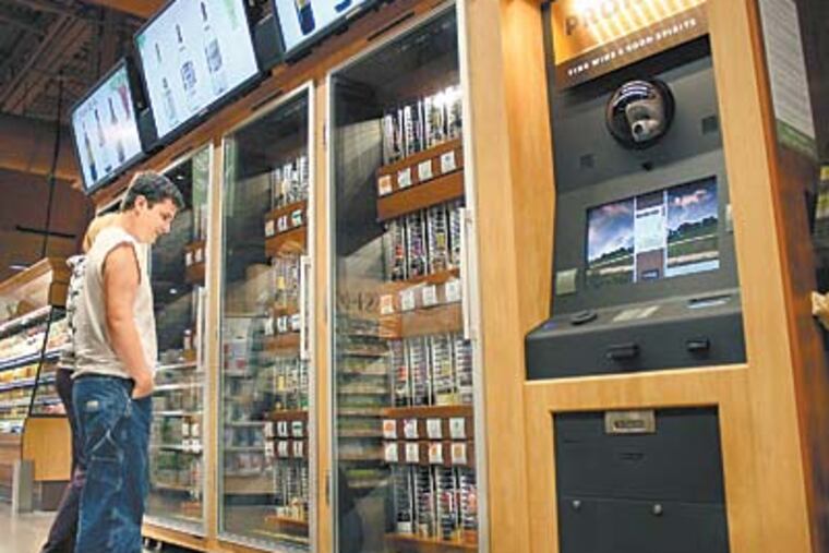 Jim Seibert and Kortney Zerphy at the wine selection at a Wegmans. A letter from the company to the LCB complained that the machines often malfunctioned. (Evan Trowbridge / Staff)