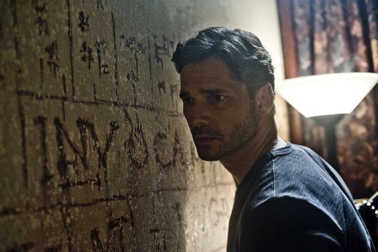 A baffled Sarchie (Eric Bana) studies wall markings as he tries to explain the strange sounds he hears in "Deliver Us From Evil."