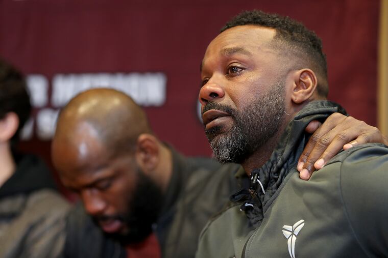 Guy Stewart, Lower Merion High School class of 1995, cries as he talks about his former teammate Kobe Bryant during a news conference. Stewart is consoled by Ryan Brooks, another former basketball player in the class of 2006.