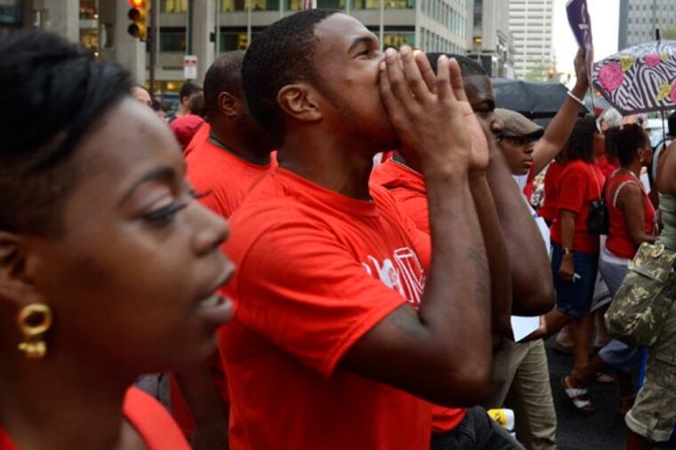 The PFT, the Philadelphia Coalition for Public Schools, students and activists march to City Hall August 21, 2013 for more school funding. They rallied first in front of Comcast headquarters, then the district's headquarters in advance of the SRC's final meeting of the summer. ( TOM GRALISH / Staff Photographer )