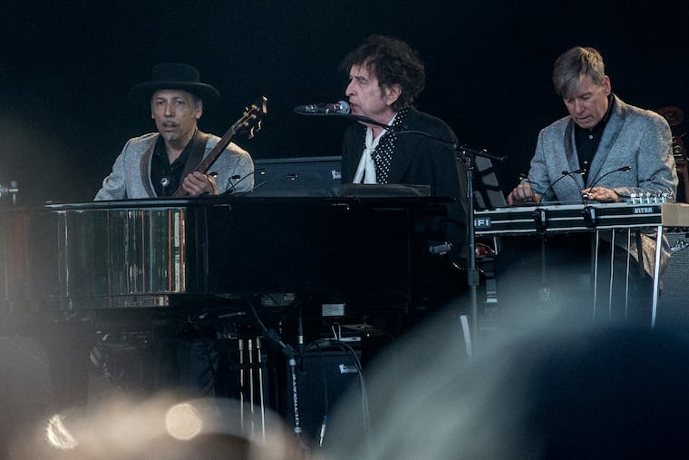 Bob Dylan with band members Tony Garnier and Donnie Herron performs at the Roskilde Festival on July 3, 2019, in Roskilde, Denmark. He played the Met Philadelphia on Monday night nd was scheduled to return on Tuesday. (Helle Arensbak/AFP via Getty Images/TNS)