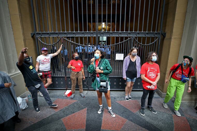 Mecca Bullock (center) of the Party for Socialism and Liberation leads a chant as a group protests the end of the Pennsylvania eviction moratorium outside Philadelphia Municipal Court on Aug. 31.