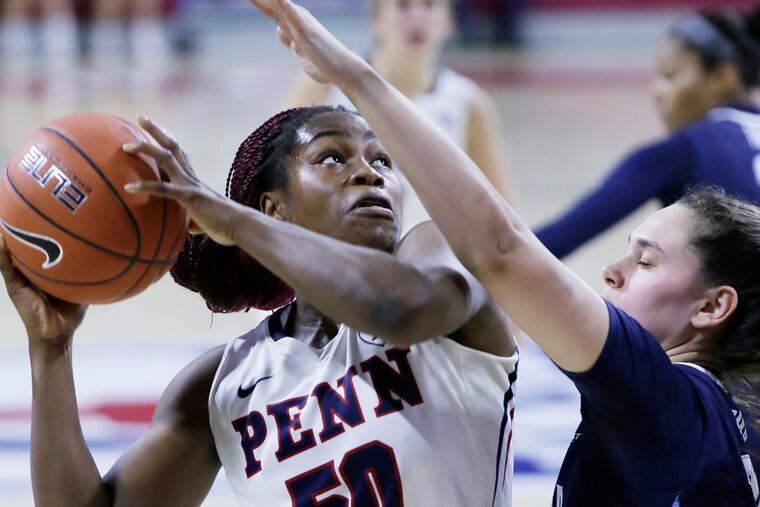 Penn's Princess Aghayere shoots over Villanova's # 30 Mary Gedaka in the first half of the Villanova's Big 5 championship win.