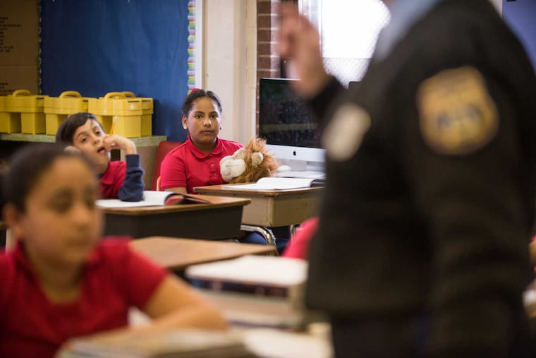 Irianisse, 11, holds a stuffed lion toy during Police Officer Wendy McGrody's D.A.R.E. lesson at William Cramp Elementary School. Daren the Lion is the mascot for the drug prevention program.