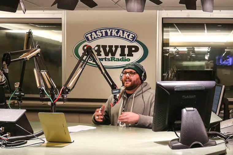 New WIP talk show host Josh Innes, a new and already very popular sports talk radio host, in the studio working. He's very animated and Stern-like on air. Wednesday, February 12, 2014. ( Steven M. Falk / Staff Photographer )