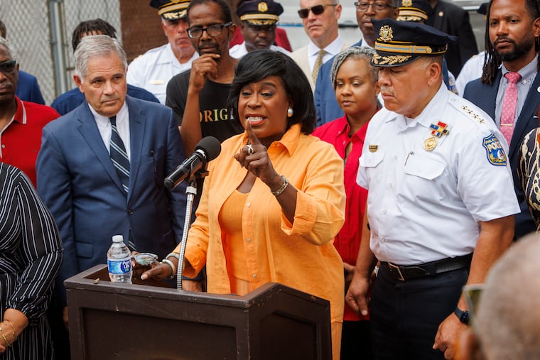 Mayor Cherelle Parker speaks during a news conference in July. At left is District Attorney Larry Krasner and at right is Police Commissioner Kevin Bethel. Parker announced this week that her administration has selected a location to construct a new police forensics lab.