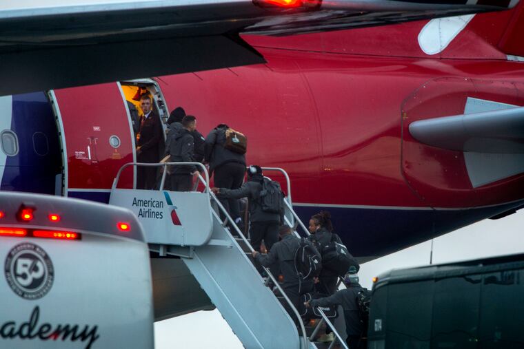 Eagles players, personnel and others (No IDs) board a charter jet at Philadelphia International Airport October 25, 2018 for the flight to London, where they will play the Jaguars at Wembley Stadium on Sunday.