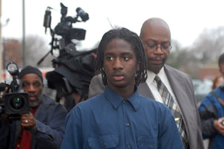Abdul Azzia Johnson, charged with murder in connection with the death of a Chester woman who was struck by a stray bullet while in a second-floor bed, is led from the Chester County Police Department. (Ron Tarver / Staff Photogapher)