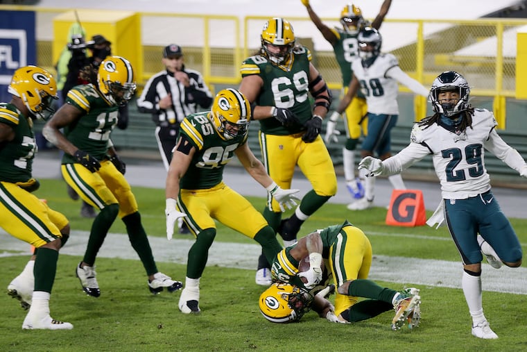 Aaron Jones (33) tumbles into the end zone for a touchdown on his fourth-quarter run that sealed the Packers' win.