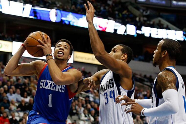 Philadelphia 76ers' Michael Carter-Williams (1) drives to the basket for a shot past Dallas Mavericks' Al-Farouq Aminu, from left, Brandan Wright (34) and Monta Ellis, right, in the first half of an NBA basketball game, Thursday, Nov. 13, 2014, in Dallas. (Tony Gutierrez/AP)