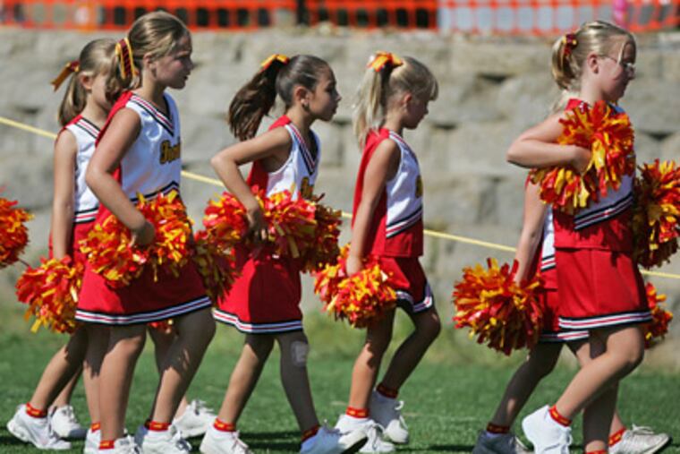 Haverford cheerleaders take to the sidelines during the inaugural games at the site of the former Haverford State Hospital. Two more athletic fields are planned, for a total of four. (David Swanson / Staff Photographer)
