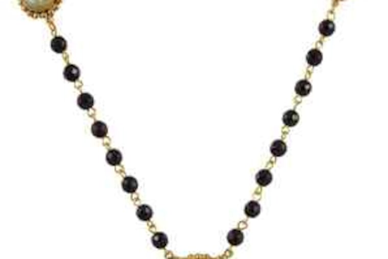 A rosary necklace and a bracelet depicting the Miraculous Medal from Virgins, Saints & Angels, based in Mexico City. Owner/designer Cheryl Finnegan says she uses religious symbols purely for their aesthetic value. Los Angeles Times