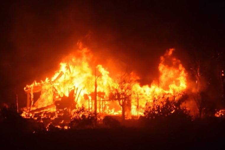 A home burns early Sunday morning off Gobernador Canyon Road in Carpinteria, Calif.