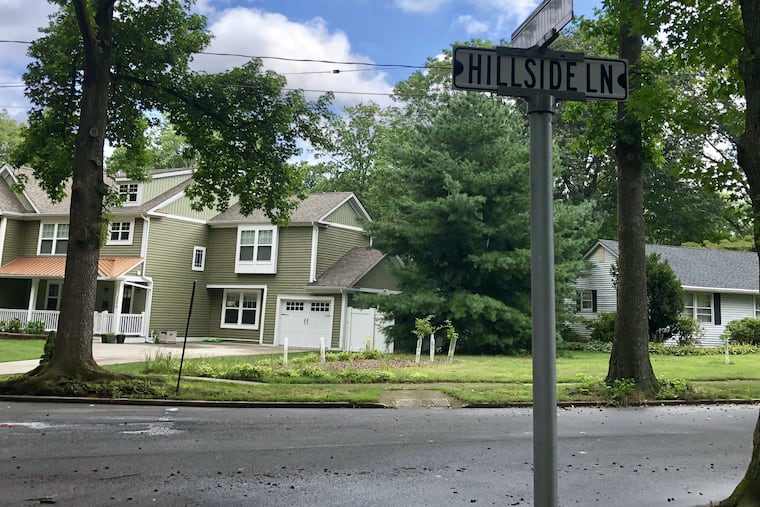 Postwar ranch home (right) in Haddonfield's Fargo section near Grove Street is dwarfed by a much larger new house. Tear-downs across the neighborhood and elsewhere in the borough are seen by some as a sign of vitality. But others fear the community's cozy character could be lost.