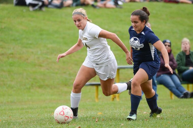 Senior striker Kate Henesey rushes by her Hallahan opponent during the Lansdale Catholic senior night on Thursday.