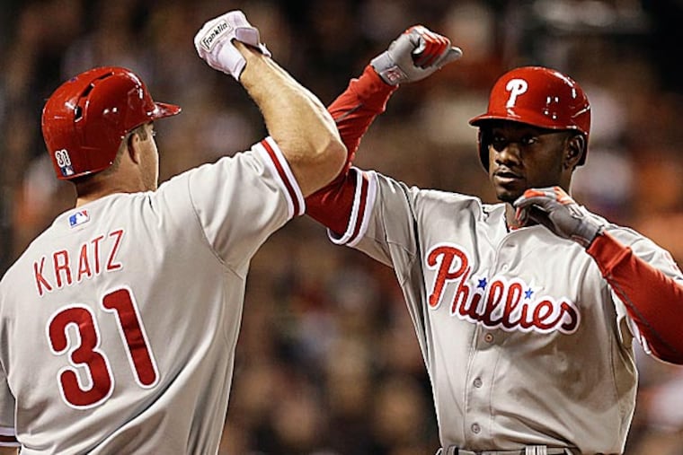 The Phillies' Domonic Brown is congratulated by Erik Kratz after hitting a home run off the Giants' Madison Bumgarner in the fifth inning. (Ben Margot/AP)