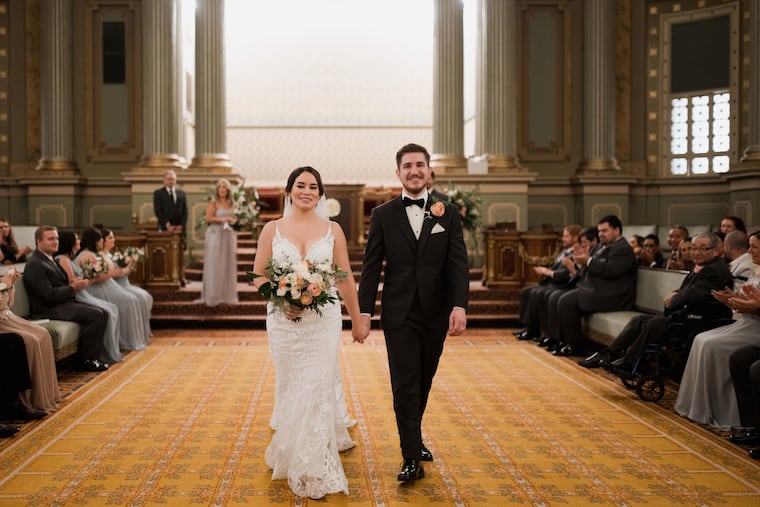 Chris and Melanie exit their wedding ceremony.