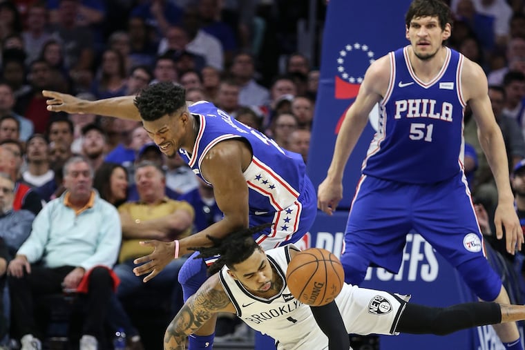 Sixers' Jimmy Butler collides with Nets' D'Angelo Russell during the 2nd quarter of Game 5 of the first round of the NBA playoffs at the Wells Fargo Center in Philadelphia, Tuesday, April 23, 2019.