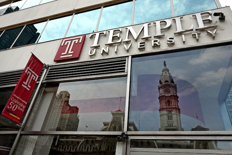 City Hall is reflected in glass of Temple University's Center City campus.