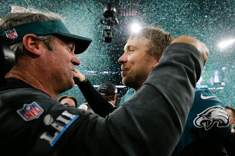 Super Bowl Champion Eagles head coach Doug Pederson and quarterback Nick Foles celebrate after beating the New England Patriots at U.S. Bank Stadium in Minneapolis February 4, 2018.