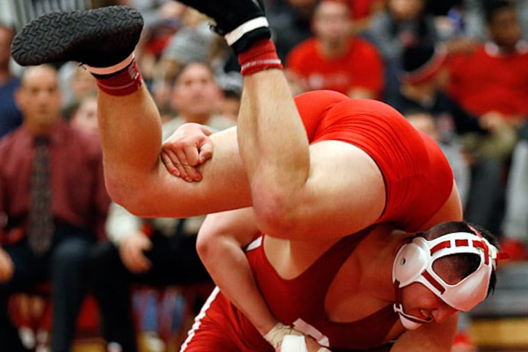 Paulsboro' Niko Savaiinaea (bottom) lifts-up Delsea's Joe Fabrizio in
the 220 pound weight class match at Paulsboro High School in wrestling
on Friday, January 23, 2015. Savaiinaea beat Fabrizio, 5-3. (Yong Kim/Staff Photographer)