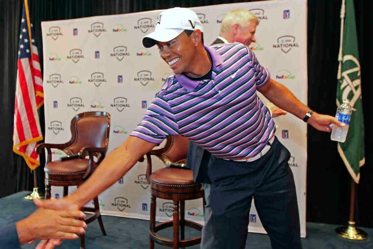 Tiger Woods works the Fourth Estate after his news conference to promote the AT&T National at Aronimink Golf Club, which benefits his charity. Questioners focused on his health problems.