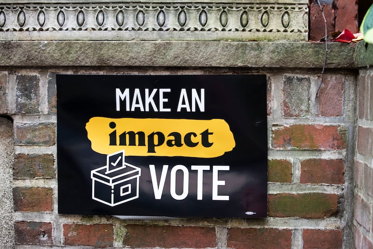 Signage reads “Make an impact VOTE” during a Get Out the Vote event in Philadelphia in 2022.
