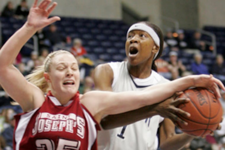 St. Joseph's Jenna Loschiavo (right) battles with Xavier's Joei Clyburn as Clyburn tries a shot during the A-10 championship.