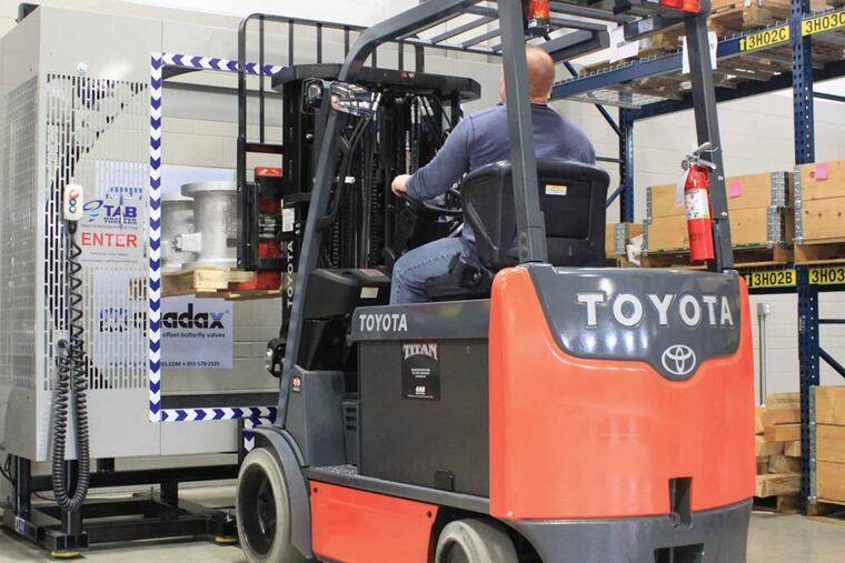 TAB Industries’ TAB Wrapper binds industrial valves to skids for shipping at German-owned Co-Ax Valves’ Bristol, Pa., warehouse. A new, automated TAB Wrapper runs by remote control, which Co-Ax managers say saves on labor and injury claims.