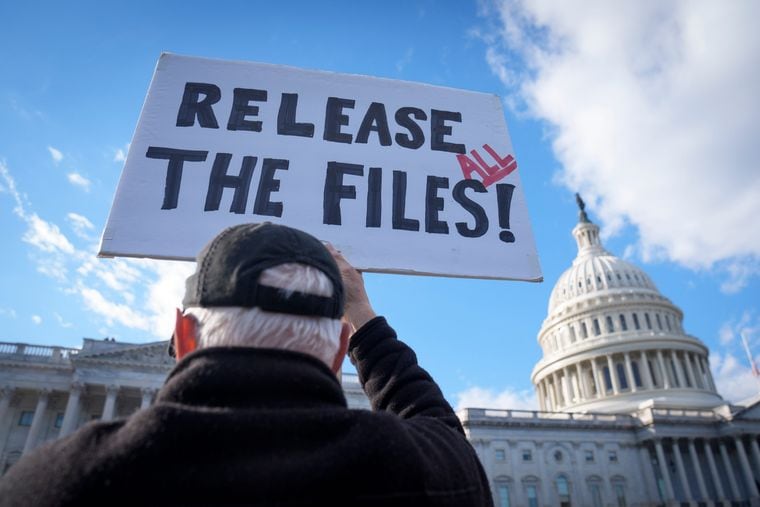 A protester holds a sign urging the release of the Jeffrey Epstein case files outside of the U.S. Capitol on Wednesday.