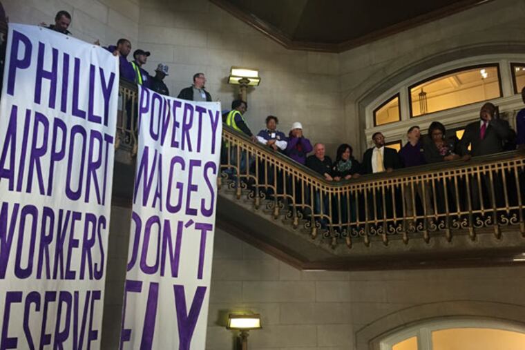 Joined by Council members in City Hall, workers from the airport protest their wages. Nearly 150 of them filled the five-floor stairwell and asked Council to pressure their employers. (TRICIA L. NADOLNY / Inquirer Staff)