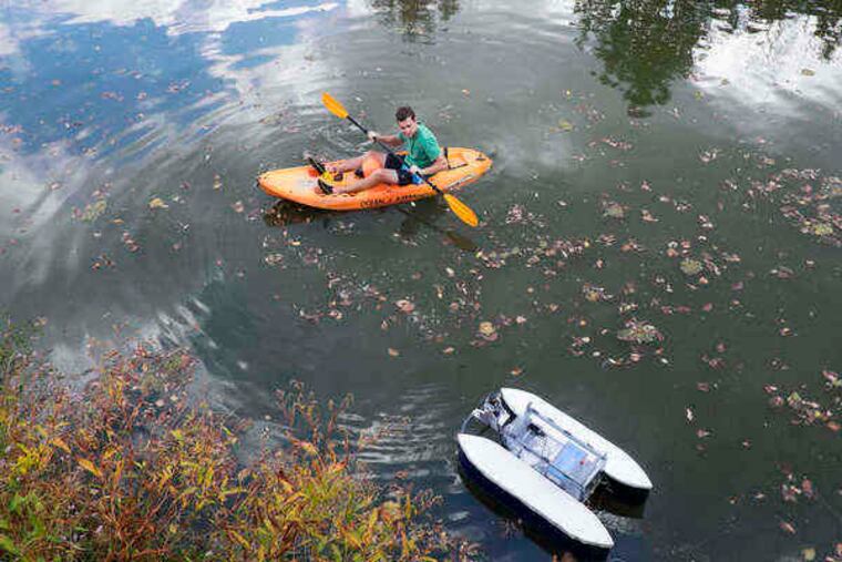 Wednesday Oct 1, 2014 Villanova engineers are headed to Singapore this month to compete in an international competition to create 16-foot self-driving boats. The students, under the direction of professor C. Nat Nataraj test their algorithms and software out on a 4 foot model of the boat on a small farm pond outside Phoenixville. Here, J. Wesley Anderson, a graduate student and team member keeps an eye on the boat as it is put through a series of exercises.( ED HILLE / Staff Photographer )