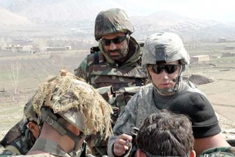 Lt. Eric Schwirian (right, wearing sunglasses) talks to his men before they begin a mission. Schwirian, a recent graduate of Drexel University, describes leading men in combat as “the greatest feeling in the world.”