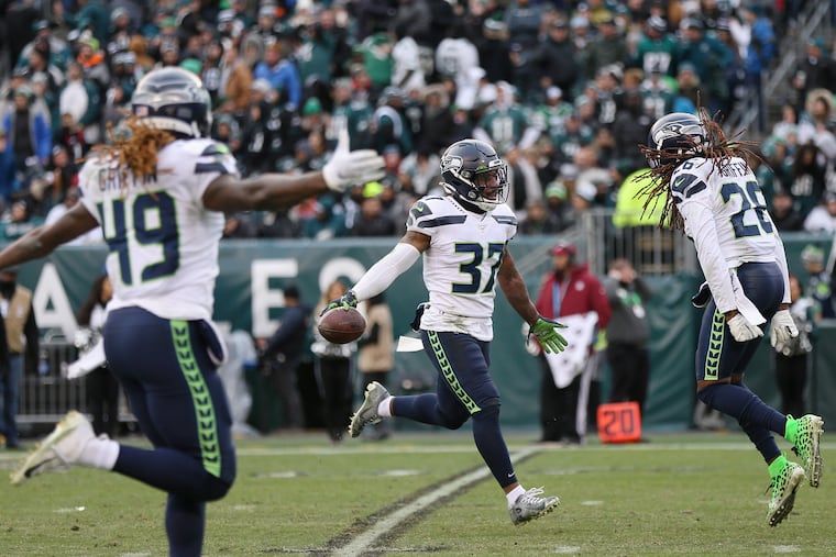 Seahawks safety Quandre Diggs (37) celebrates with linebacker Shaquem Griffin (49) and cornerback Shaquill Griffin (26) after recovering a fumble in the fourth quarter of their Week 12 win against the Eagles. Seattle is the only NFC team the Eagles have never played in the postseason -- until now.