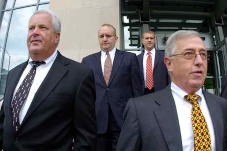 Former Luzerne County Judges Michael T. Conahan (front left) and Mark A. Ciavarella Jr. (front right) leaving the federal courthouse in Scranton after their September arraignment. (Mark Moran / Wilkes-Barre Citizens Voice)