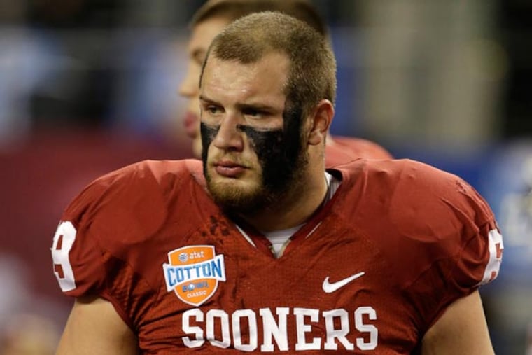 Lane Johnson (69) on the field during warm ups bofore the Cotton Bowl NCAA college football game against Texas A&M Friday, Jan. 4, 2013, in Arlington, Texas. (Tony Gutierrez/AP)