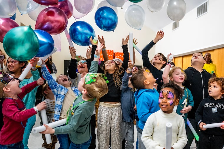 Balloons drop at the stroke of 12 p.m, as kids ring in the New Year with a Noon-Year's Eve Party in Maple Shade.