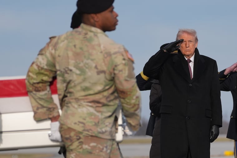 President Donald Trump salutes as an Army carry team moves the flag-draped transfer case with the remains of Iowa National Guard Sgt. Edgar Brian Torres-Tovar, 25, of Des Moines, Iowa, at Dover Air Force Base on Wednesday.
