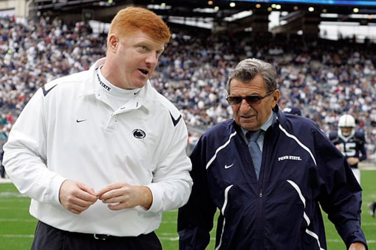 FILE - In this Oct. 10, 2009 file photo, Penn State coach Joe Paterno, right, and assistant coach Mike McQueary walk off the field together before an NCAA college football game against Eastern Illinois in State College, Pa. On Sunday, Jan. 22, 2012, family says Paterno, winningest coach in major college football, has died. (AP Photo/Carolyn Kaster, File)
