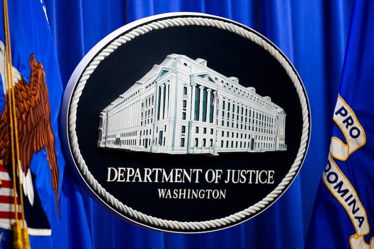 The U.S. Department of Justice logo is seen before a news conference, Monday, May 4, 2026, in Washington.