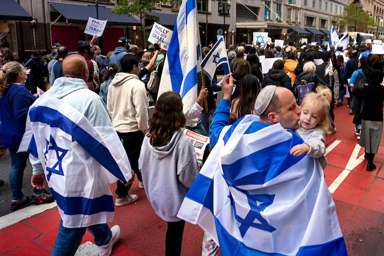 Benaya Yehuda kisses 21 month-old Yarid as they march from City Hall to Independence Hall with the Jewish Federation of Greater Philadelphia Monday, Oct. 16, 2023. Yehuda moved from Israel a year ago. The march ended with a rally to show solidarity with Israel, with “songs, messages and prayers of unity.”