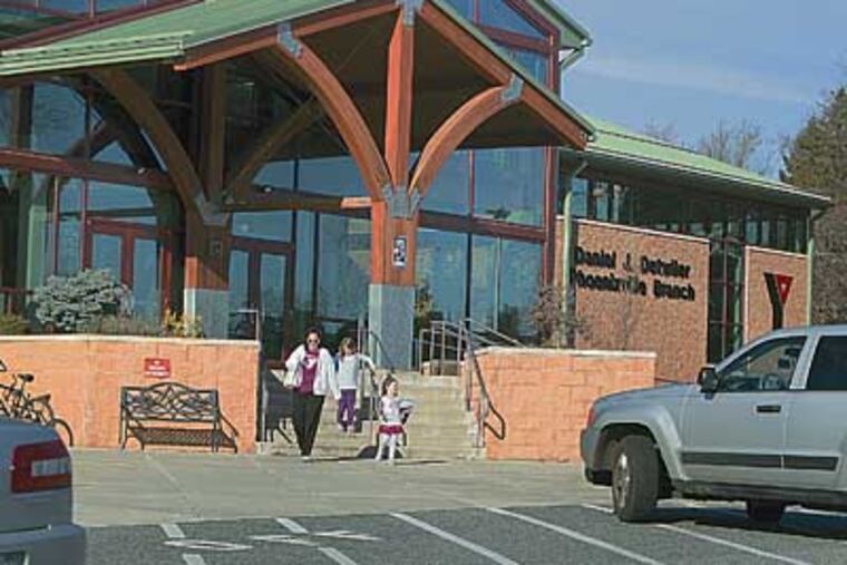 Jennifer Notwick and daughters Kelsey and Jillian leave the Phoenixville YMCA, part of the Freedom Valley association, which is joining with Philadelphia and Vicinity. ED HILLE / Staff Photographer