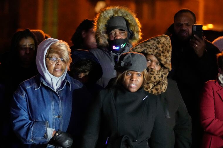 Rodney Wells, center, stepfather of Tyre Nichols, listens to speakers at a prayer gathering at the site where Nichols was beaten by Memphis police officers, and later died from his injuries, in Memphis, Tenn., on Monday.