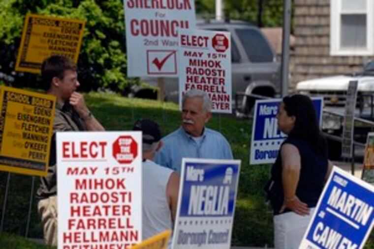A proposed $30 million K-12 school in Morrisville was the focus of the Morrisville school board election. Jim Gafgen (center) talks with Fred Kerner and Nancy Sherlock after voting at the Morrisville Public Library. Twelve candidates were vying for six seats on the Morrisville board.