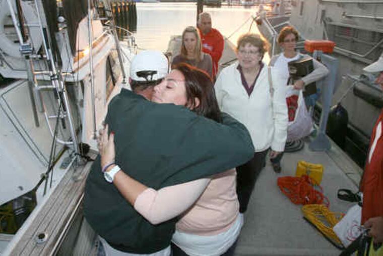 Bernie Otremsky is hugged by his daughter Erin as family members of the rescued men look on. Before their rescue, the mem had feared the worst: "We kept quiet about it, but we were all thinking it, that this was probably going to be the end," said one, Geoffrey McDade.