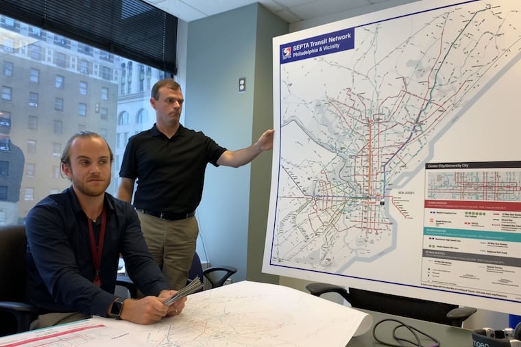 SEPTA's Lex Powers (right) and Andrew Busch show off the new transit system map, which will soon show up across the city.